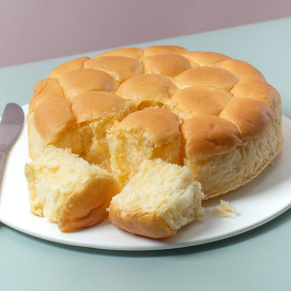 Freshly baked Conti’s Dinner Rolls – soft, fluffy, and golden brown.